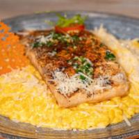 Risotto A La Huancaina Con Salmon · Risotto with a mild yellow chile sauce topped with grilled salmon.