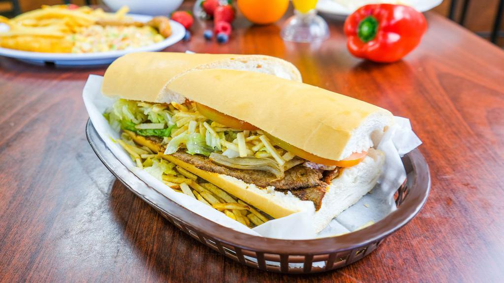 Pan Con Bistec · Cuban bread with a palomilla steak, julienne fries, lettuce, tomato and mayonnaise.

Pan cubano con bistec de palomilla, papitas  juliana, lechuga, tomate y mayonesa.