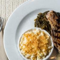Grilled Cheshire Pork Chop · Four cheese mac, pot likker collards, ancho molasses glaze