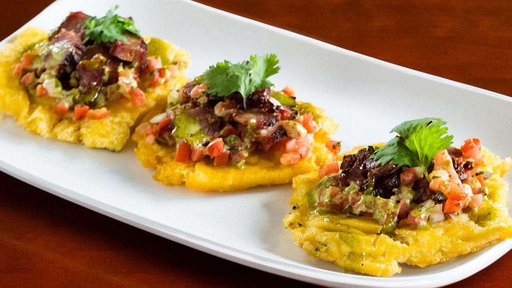 Bbq Tostones (Appetizer) · Three crispy tostones covered with Beef Brisket, Pulled Chicken or Chopped Pork topped with Pico de Gallo and Cilantro Aioli sauce.