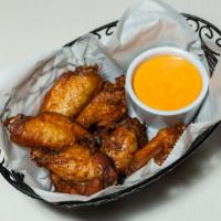 Chicken Wings · Deep fried marinated chicken wings. Served with sweet chili sauce.