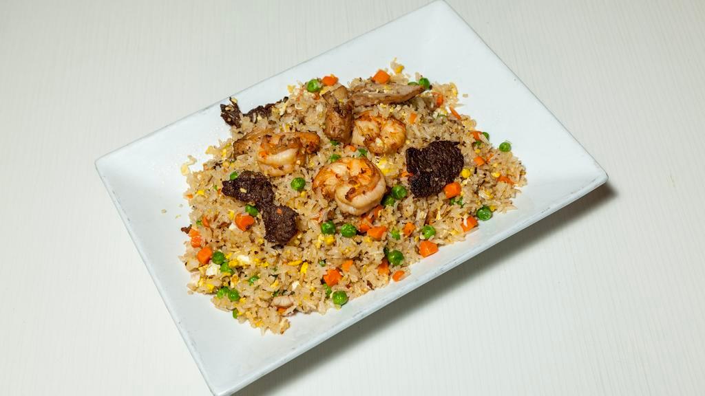 House Special Fried Rice · Fried rice with egg, beef, chicken, shrimp, onions, peas, and carrots.