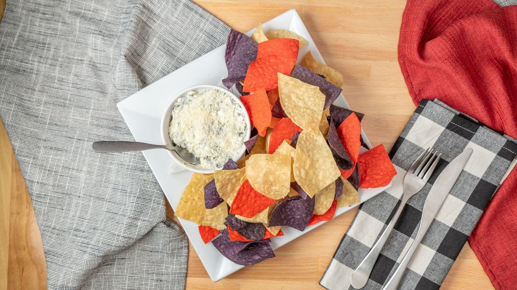 Spinach & Artichoke Dip · Delicious blend of artichoke hearts, spinach, garlic, parmesan and cream cheese, lightly seasoned and made for spreading, served with fresh cooked corn tortilla chips.