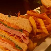 Club · Ham, turkey, bacon, american cheese, leaf lettuce and sliced tomato, layered on three slices...