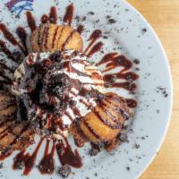 Fried Oreo · Oreo cookies hand dipped in funnel cake batter then golden fried, served with a scoop of van...