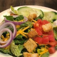 House Salad · Fresh crisp greens topped with. tomatoes, cheese, croutons,. cucumbers, red onion and. green...