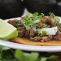 Tacos Azada (Steak) · With cilantro and onions.
