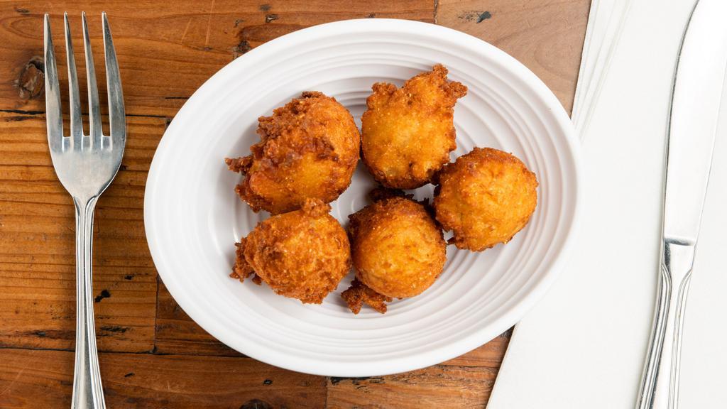 Hush Puppies (5) · House-made dough, fried golden, and served fresh with our house jam.