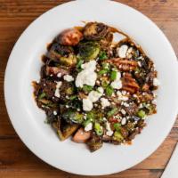 Chef Jason'S Brussels · Crispy Brussel sprouts, balsamic reduction, local azar sausage, bacon, caramelized onion, go...