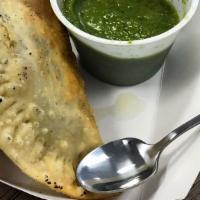 Beef Empanada  · Beef empanada made with onions egg and Peruvian seasoning comes with a side of Peruvian gree...