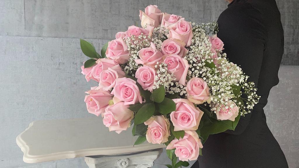 Pink World · 24 Light Pink Roses hand wrapped and delivered to your special person.