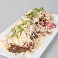 Special Fried Green Plantains · Special fried green plantains with shredded white cheese and pink sauce.