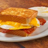 Bacon Egg And Cheese Melt With Grits · Two strips of Applewood smoked bacon, two farm-fresh eggs cooked to order, and American chee...