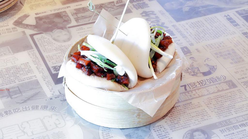 Chinese Bbq Pork Bao · Two fluffy bao buns, filled with sweet & saucy roasted pork shoulder, wok-fired with hoisin sauce and caramelized onions. Topped with spring onions.