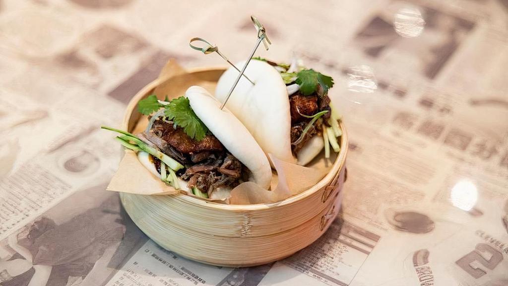 Roast Duck Bao · Five-spice hand-pulled duck and crispy. skin with housemade black vinegar hoisin,. cucumbers, spring onions, and cilantro.