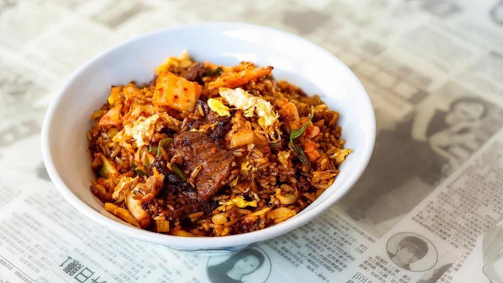 Kimchi Fried Rice · Spicy housemade kimchi, steak, egg,. onions, soy and gochujang sauce.