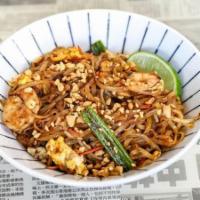 Pad Thai · A Hawkers staple. Rice noodles with shrimp and sliced chicken, wok-fired in a tangy, red chi...