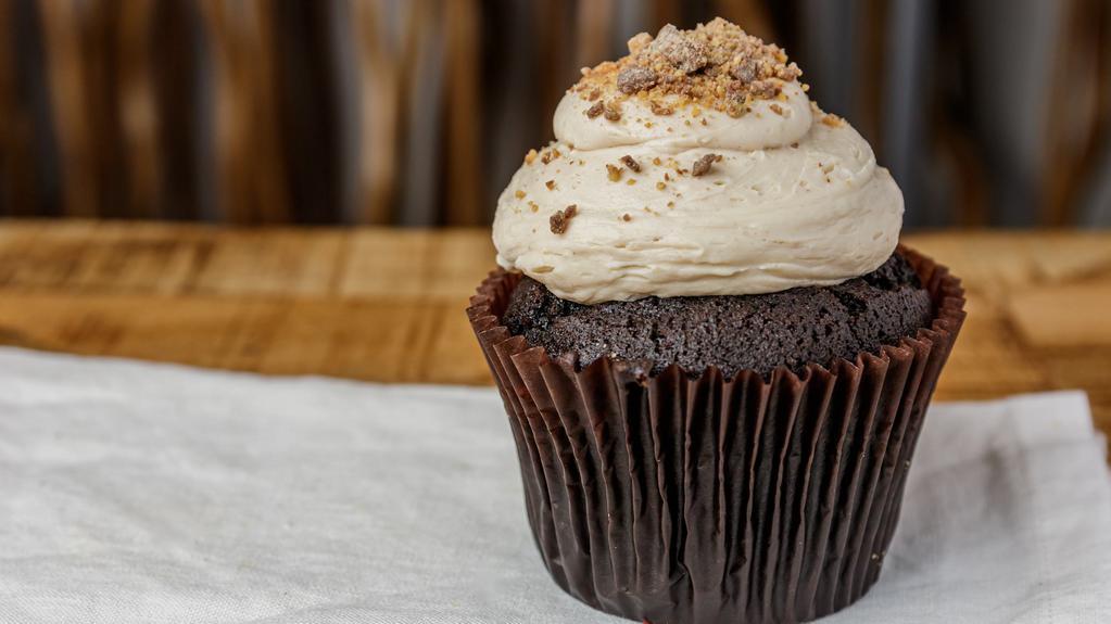 Peanut Butter Cup · Chocolate cake with peanut butter cream cheese frosting topped with crumbled peanut butter cups.