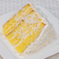 Island Coconut Cream · Butter cake like-no-other cake topped with coconut cream icing and fresh coconut flakes.