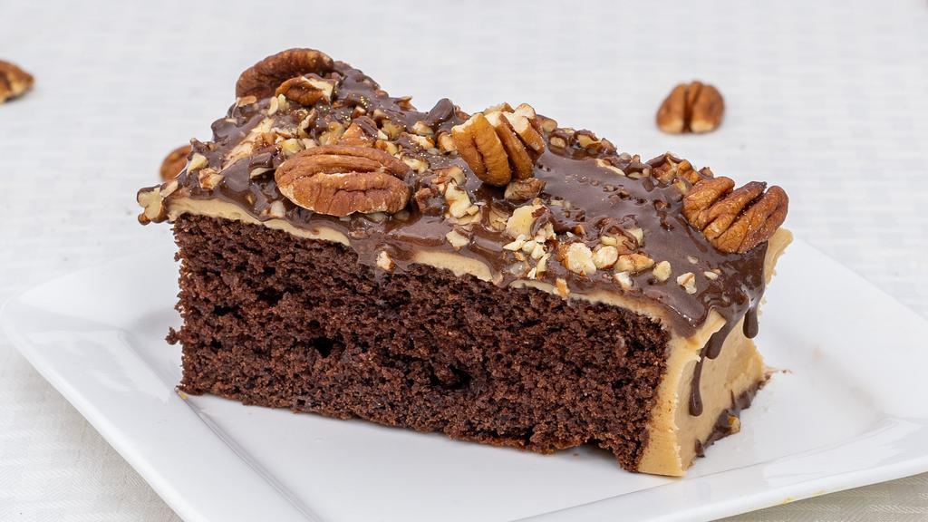 Chocolate Turtle · Delectable chocolate cake, topped with Coco's celebrated caramel icing, pecans & chocolate drizzle.
