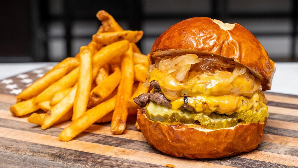 Social Smash Burger · Two ¼ lb. Smashed Patties, American Cheese, Smash Sauce, Pickles, Caramelized Onions, Pretzel Bun