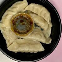 Fried Or Steamed Dumpling (8) · Pork Dumplings with a side of sauce