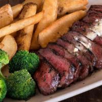 Steak Frites · Marinated flat-iron steak grilled & thinly sliced, topped with garlic butter & served with s...