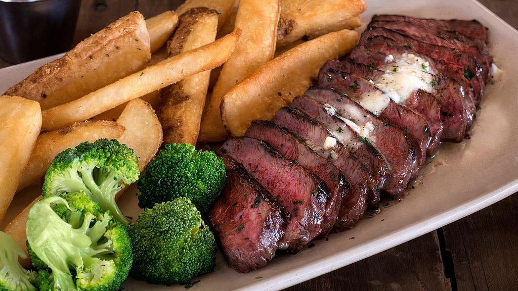 Steak Frites · Marinated flat-iron steak grilled & thinly sliced, topped with garlic butter & served with steamed broccoli, fries & garlic aioli for dipping.
