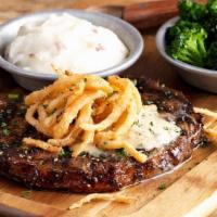 Grilled Ribeye · 12 oz. USDA Choice Ribeye seasoned & grilled topped with Stout butter & fried onions, served...