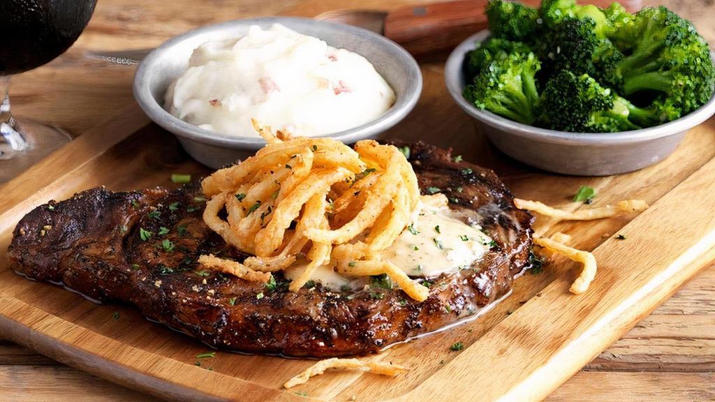 Grilled Ribeye · 12 oz. USDA Choice Ribeye seasoned & grilled topped with Stout butter & fried onions, served with red skin mashed potatoes & steamed broccoli.