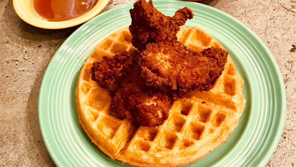 Chicken And Waffles · A Golden Belgian Waffle topped with our Crispy Buttermilk Fried Chicken Tenders.  Served with butter and syrup.