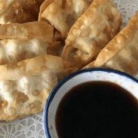 Gyoza · (Fried or Steam) Chicken pot stickers served with chili oil dipping sauce