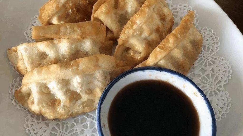 Gyoza · (Fried or Steam) Chicken pot stickers served with chili oil dipping sauce