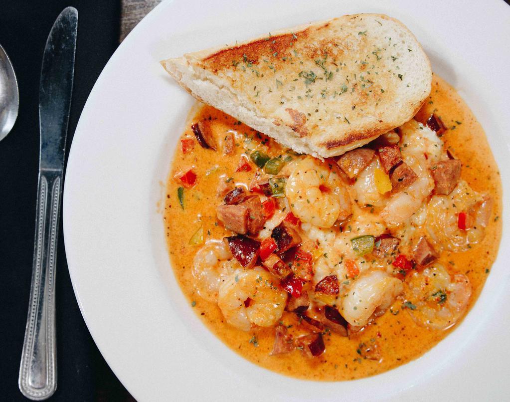 Shrimp & Grits · Lightly seasoned shrimp sautéed with andouille sausage, onions, and peppers. Served in a roasted red pepper cream sauce over cheese grits with toasted garlic bread. Gluten Free (without toast)