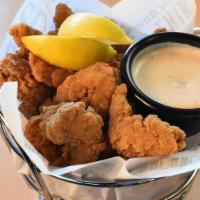 Popcorn Shrimp Basket · A generous helping of our delicious tail-less popcorn shrimp served with tangy tartar sauce ...