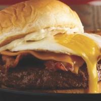 Bacon, Egg And Cheeseburger · Three strips of bacon, cheddar cheese, an over easy fried egg and mayo..
