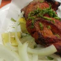 Tandoori Chicken Leg · Chicken leg cooked with tandoori masala served with paratha.
