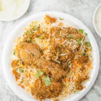 Chicken Biryani · Chicken marinated with spices and then cooked with basmati rice. Served with raita and salad.