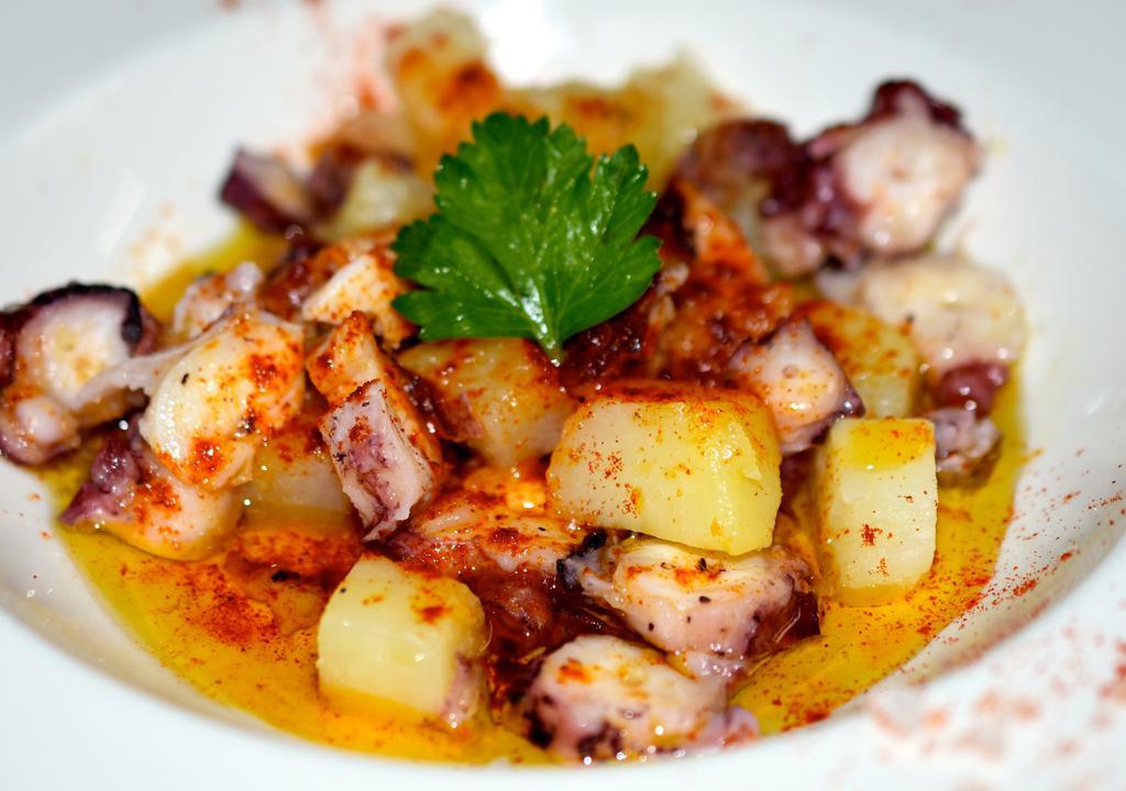 Pulpo A La Parrilla Pequeño · Boiled Galician baby octopus served with boiled potatoes, olive oil, sea salt and Pimentón de La Vera. Gluten free.