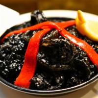 Arroz Meloso Negro · Black risotto. Calasparras rice, calamari, natural squid ink from Galicia, Spain.
Gluten free.