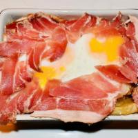 Huevos Rotos · Thin-sliced baked potatoes, two sunny side-up eggs, and serrano ham. Add Spanish sausage and...