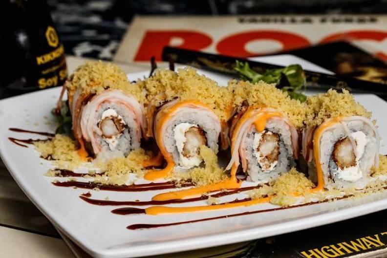 Metalhead · Enter delicious. Shrimp tempura and cream cheese inside, crab stick outside, topped with spicy mayo, eel sauce, and crunchy flakes.