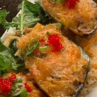 Mussel Dynamite · Baked mussel topped with dynamite seafood mix