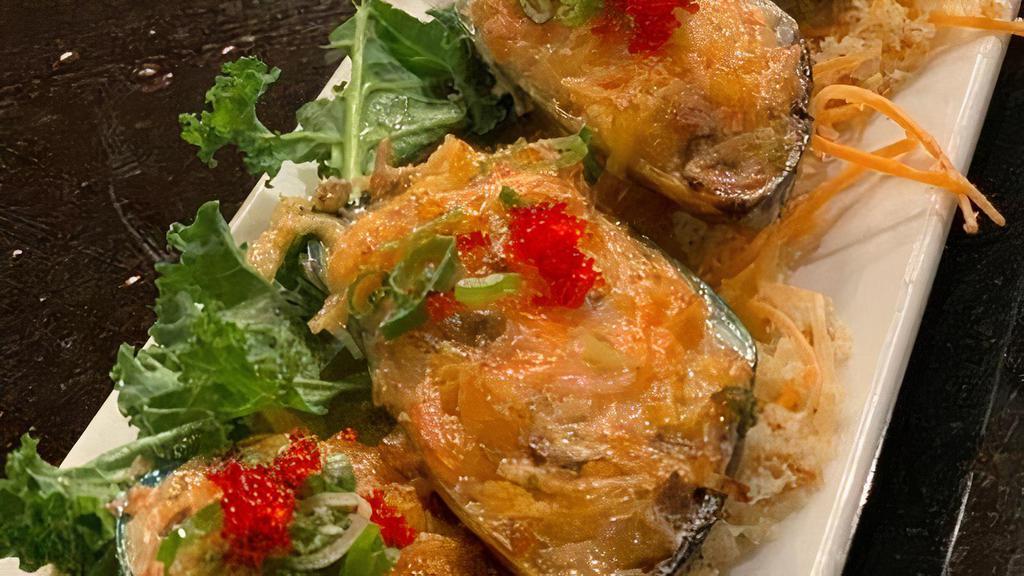 Mussel Dynamite · Baked mussel topped with dynamite seafood mix