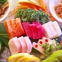 Sashimi Deluxe · Chef choice sushi roll and 15 pcs of sashimi **Raw/undercooked**. (Substitutions)