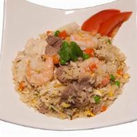 House Fried Rice · Fried rice in brown sauce with chicken, beef, shrimp, onion, tomato, pea, carrot and egg.