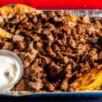Nachos De Asada · Fresh tortilla chips topped with refried beans, cheese, and grilled steak.