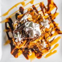 Fried Ice Cream · Deep-fried vanilla ice cream covered in sesame seeds and corn flakes. Topped with Nutella, H...
