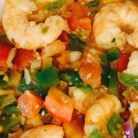 Shrimp & Grits · A spicy broth of tomatoes, onions, garlic, green peppers, cajun seasoning and sauteed shrimp...