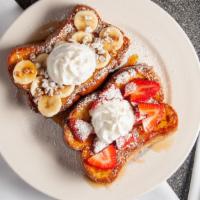 Banana Nut French Toast · Two French toast, topped with bananas, pecans, whipped cream and powdered sugar.